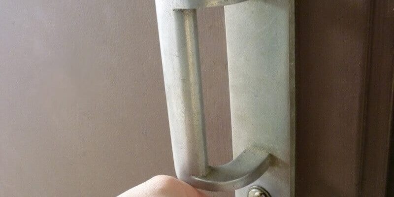 hand opening a door lock